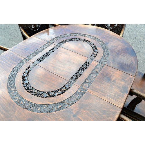 222b - An antique carved wooden Anglo-Indian dining table and 6 carver chairs. All decorated and pierced wi... 