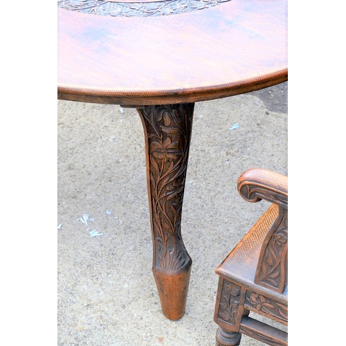 222b - An antique carved wooden Anglo-Indian dining table and 6 carver chairs. All decorated and pierced wi... 