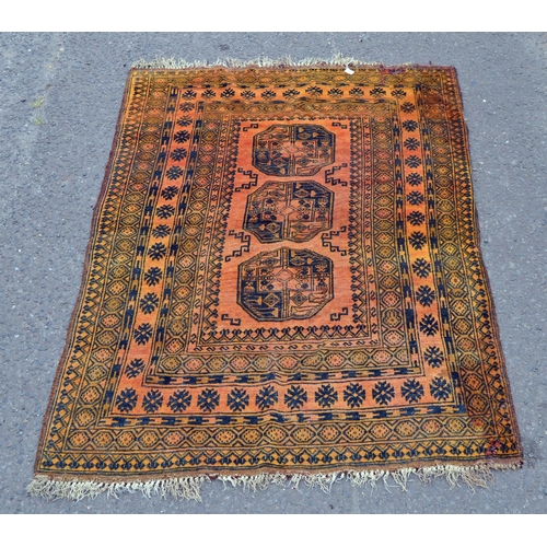 108 - A large orange ground rug with 3 central medallions