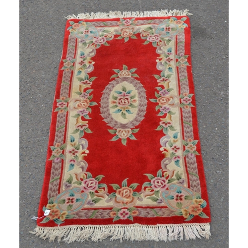 111 - A red ground rug with central medallion