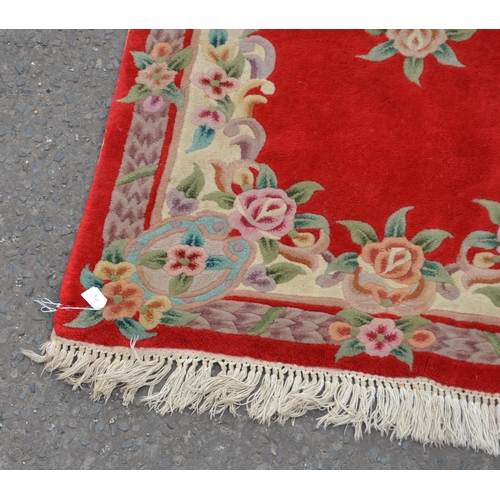 111 - A red ground rug with central medallion