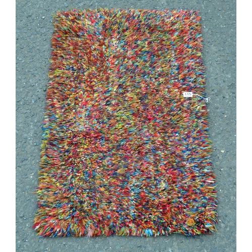 115 - A multi- coloured fluffy rug