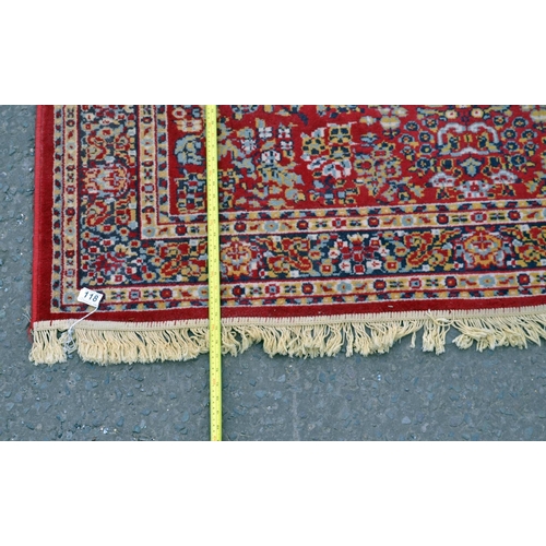118 - A large red ground rug with Herati border - Postage/packing not available.