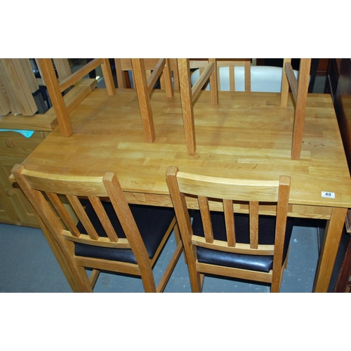 48 - A light oak dining table and 6 chairs - Postage/packing not available.