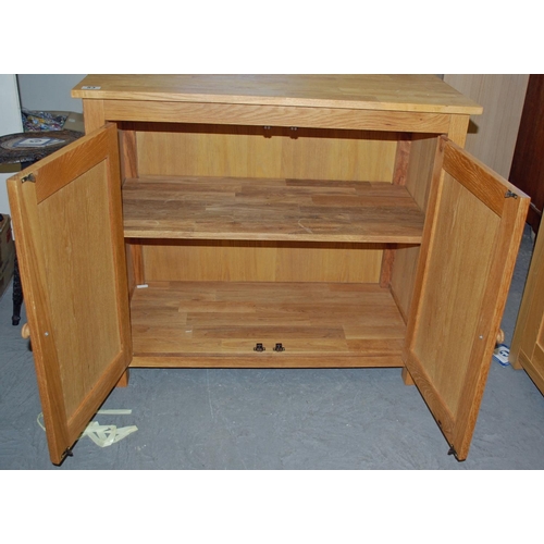 53 - Light oak 2 door cupboard - Postage/packing not available.