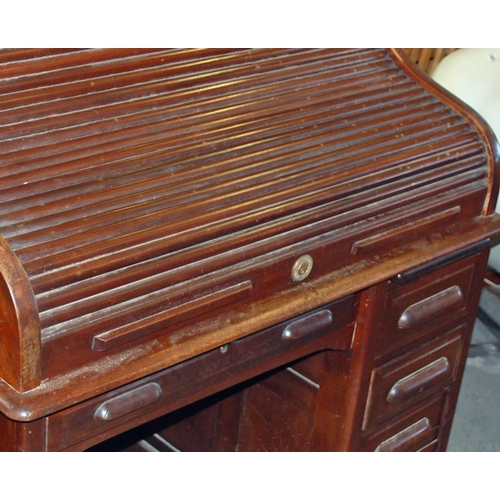 91 - A vintage Maple & Co rolltop desk - Postage/packing not available.