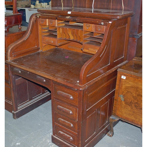 91 - A vintage Maple & Co rolltop desk - Postage/packing not available.