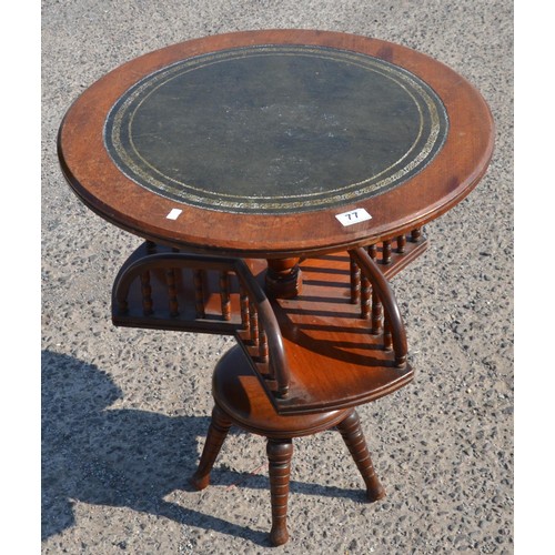 77 - An unusual leather topped table with rotating gallery base - Postage/packing not available.