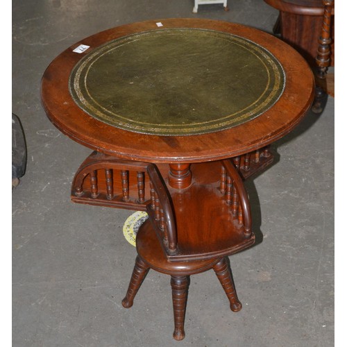 77 - An unusual leather topped table with rotating gallery base - Postage/packing not available.