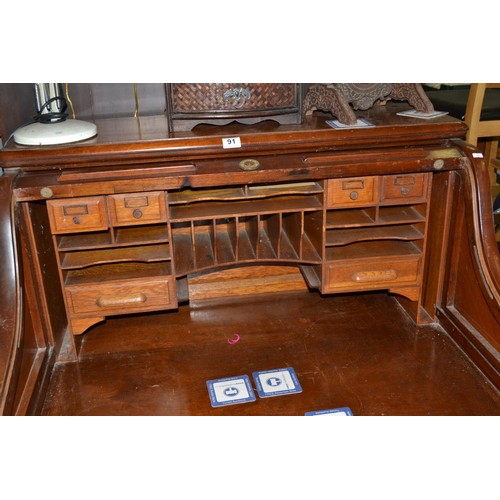 91 - A vintage Maple & Co rolltop desk - Postage/packing not available.