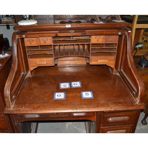 91 - A vintage Maple & Co rolltop desk - Postage/packing not available.