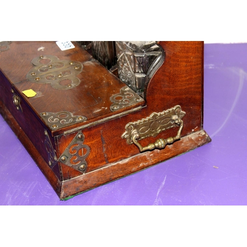 330 - An antique oak cased 3 bottle tantalus - Postage/packing not available