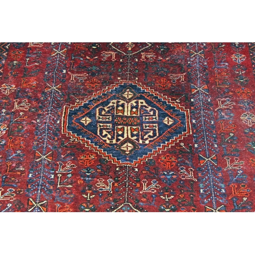 255 - A large Iranian handmade Kashgai rug with red and blue ground - Postage/ Packing not available