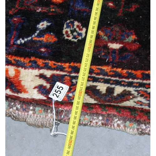 255 - A large Iranian handmade Kashgai rug with red and blue ground - Postage/ Packing not available