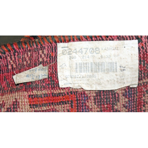 255 - A large Iranian handmade Kashgai rug with red and blue ground - Postage/ Packing not available