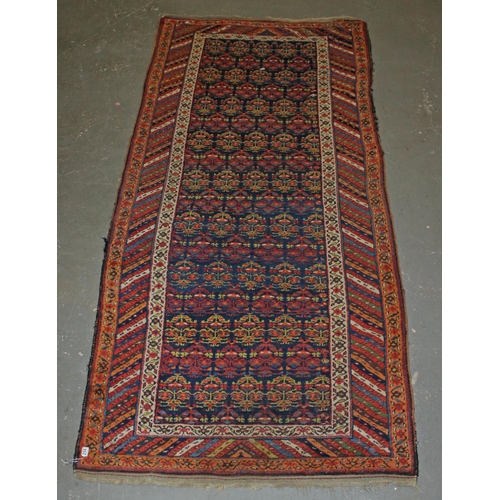 258 - A vintage long wide multi-coloured runner rug believed to be handmade