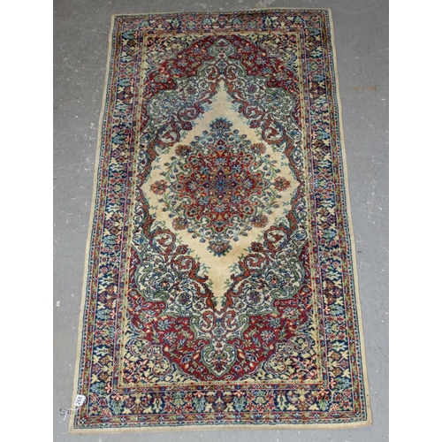 268 - A cream and red ground rug with large medallion