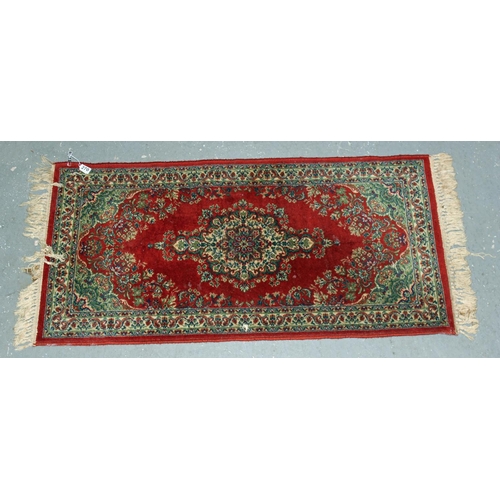 270 - Small red ground rug with central medallion