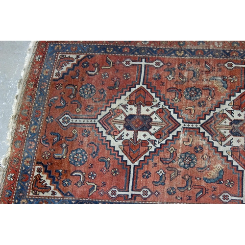 271 - An antique blue and red ground rug with 2 central medallions