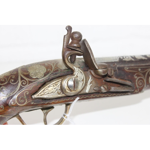 1011 - A flintlock pistol with extensive silver inlay - believed to be French c. early 19th century