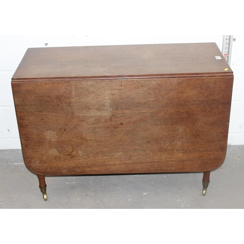 122 - A Victorian Mahogany drop leaf table on brass casters