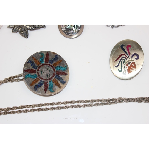 1258 - 7 silver and white metal pendants and brooches