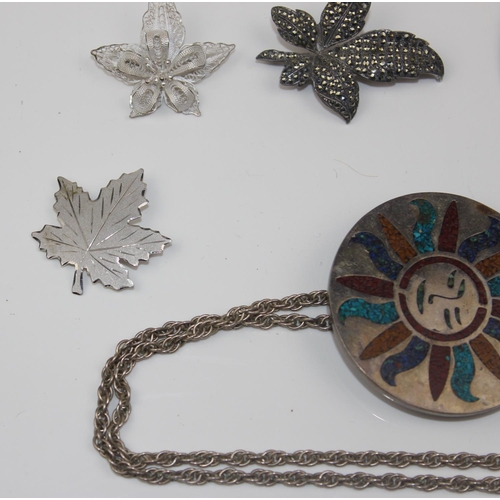 1258 - 7 silver and white metal pendants and brooches