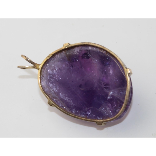 1264 - A large purple stone pendant (believed to be an uncut Amethyst) in a yellow metal mount marked 14k