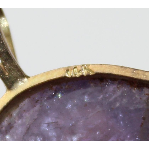 1264 - A large purple stone pendant (believed to be an uncut Amethyst) in a yellow metal mount marked 14k