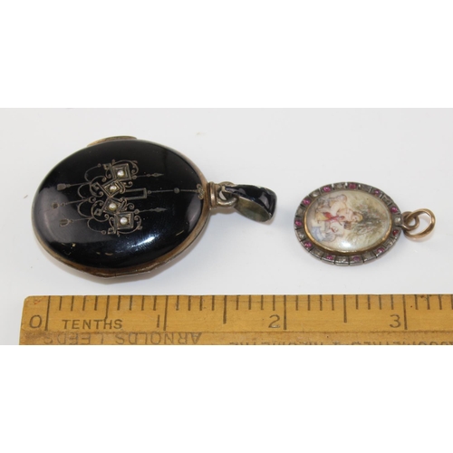 1265 - 2 antique pendants - one a black enamel and seed pearl set locket bearing indecipherable marks and t... 