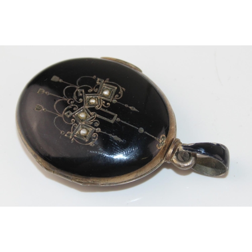 1265 - 2 antique pendants - one a black enamel and seed pearl set locket bearing indecipherable marks and t... 