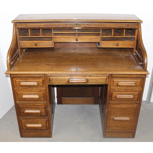 141 - An early 20th century Oak roll-top desk with key