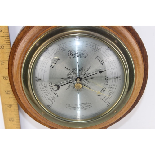 1443 - A 20th century aneroid wheel barometer by Comitti of London - with paperwork