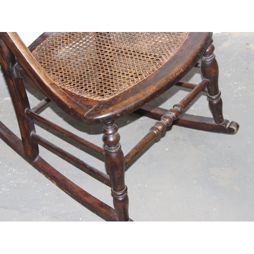 149 - An early 20th century bergere seated rocking chair