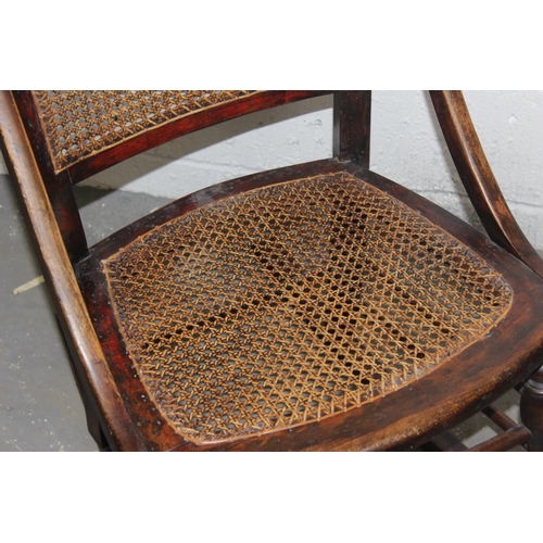 149 - An early 20th century bergere seated rocking chair