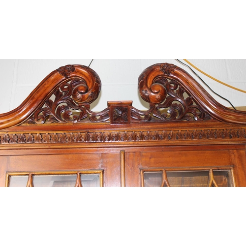 150 - A George III style astral glazed bureau bookcase with decorative fretwork swan-neck pediment