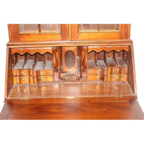 150 - A George III style astral glazed bureau bookcase with decorative fretwork swan-neck pediment