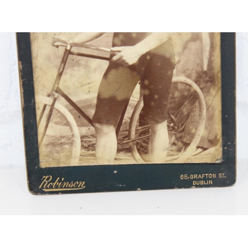 1584 - An antique photograph of a cycle club member in antique mirrored frame by Robinson of Dublin