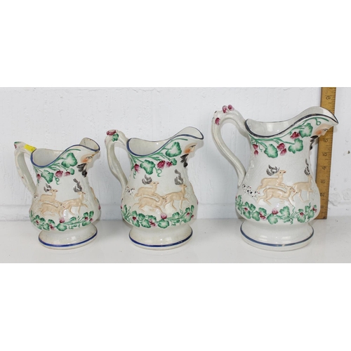 1825 - A set of 3 Victorian Prattware style relief moulded pottery jugs decorated with hunting scenes and B... 