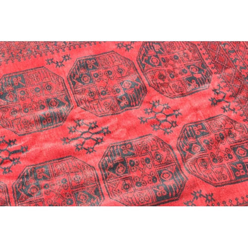 255 - A large red and black ground Afghan 10 medallion rug with concentric geometric borders