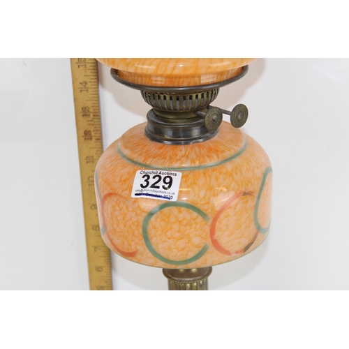 329 - An antique oil lamp and glass shade by Duplex