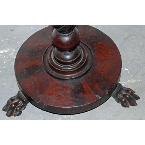 36 - A Victorian mahogany table standing on paw feet with twisted support