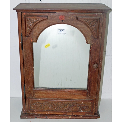 41 - A vintage mirrored cabinet with carved details