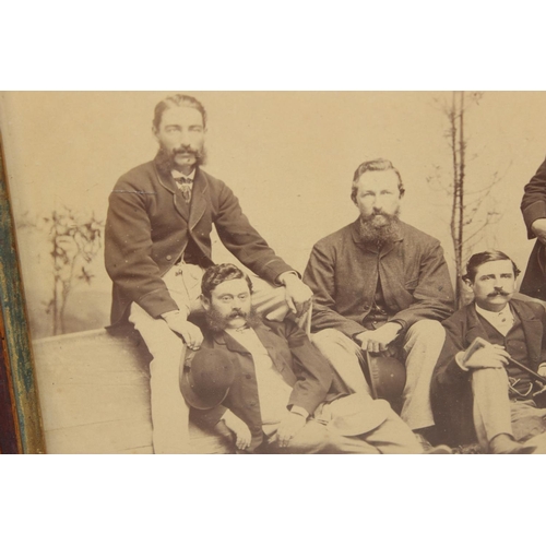 411 - An antique group photo of gentlemen set within a highly decorative Oriental carved wooden frame