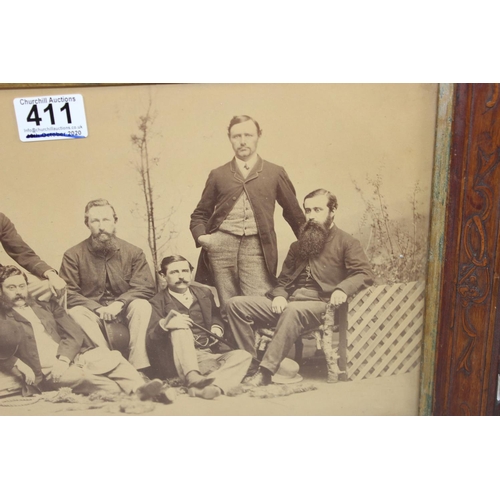 411 - An antique group photo of gentlemen set within a highly decorative Oriental carved wooden frame