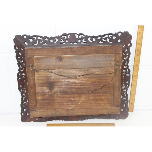 411 - An antique group photo of gentlemen set within a highly decorative Oriental carved wooden frame