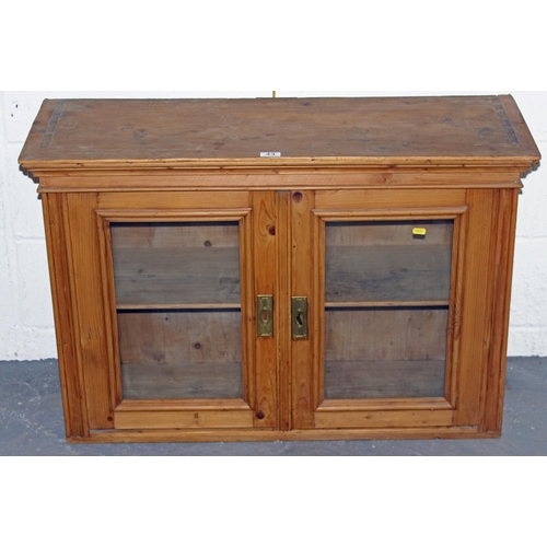 43 - An antique pine glazed cabinet