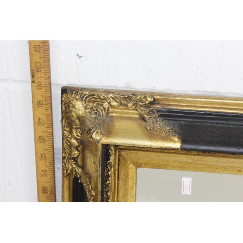 436 - A Victorian style gilt and black framed mirror