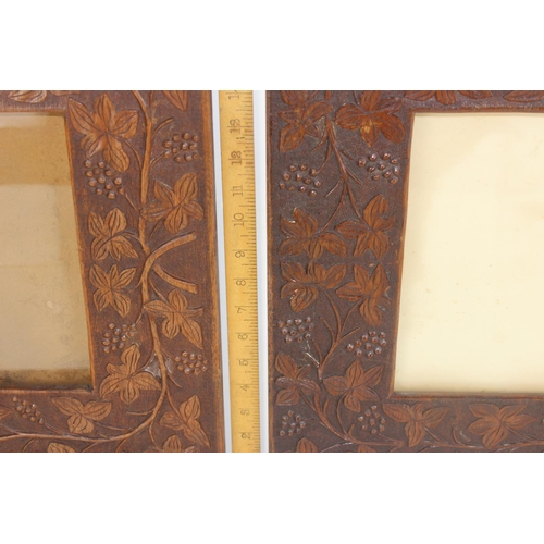 490 - A pair of Arts & Crafts period carved Oak frames decorated with fruiting vines