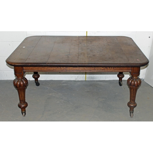 57 - A Victorian oak dining table with impressive carved legs